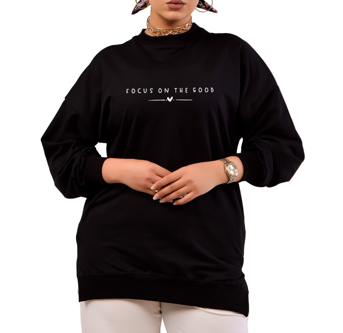 Person wearing a black sweatshirt with 'Focus on the Good' text on a plain background