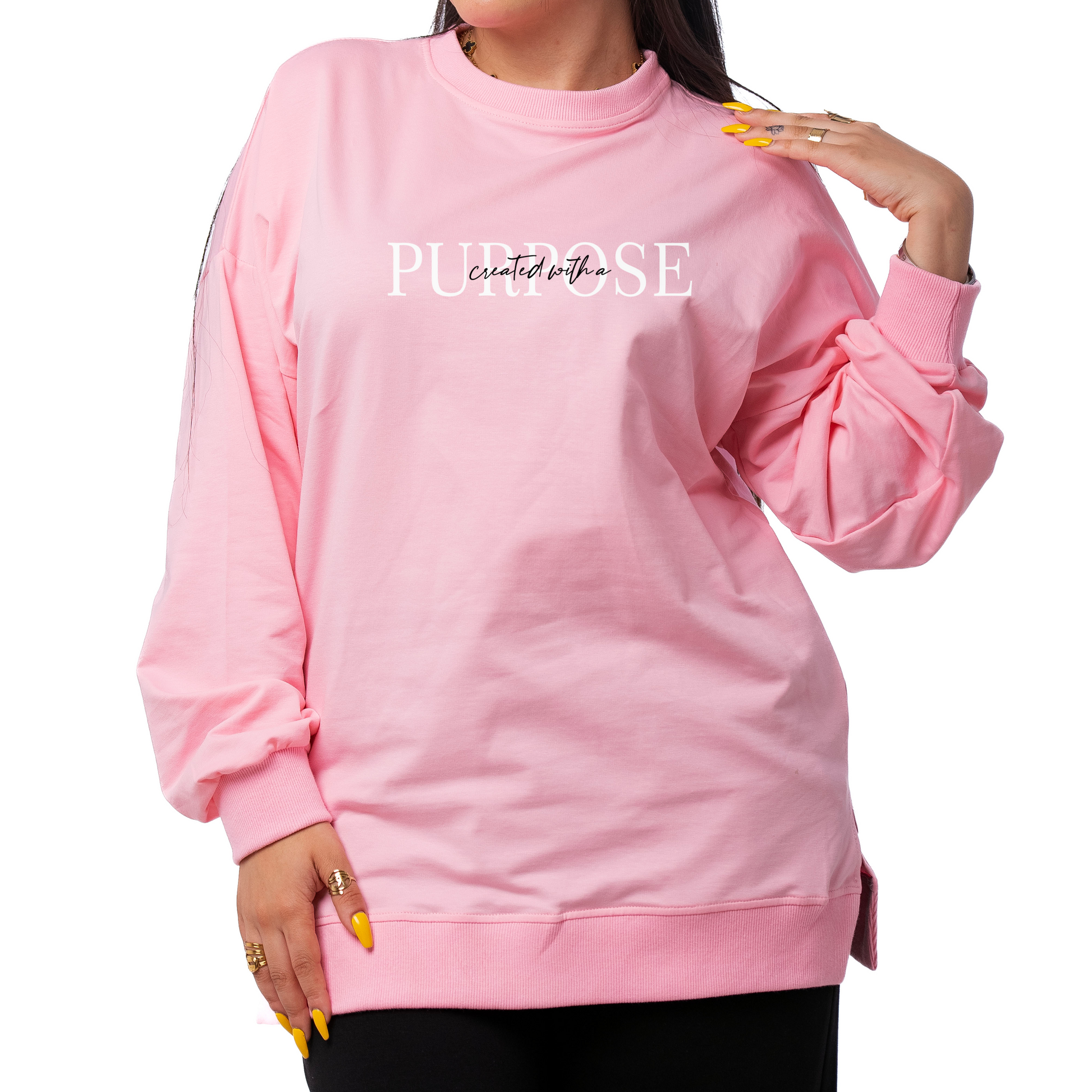 Woman wearing a pink sweatshirt with text on a white background